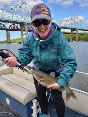 woman holding a catfish